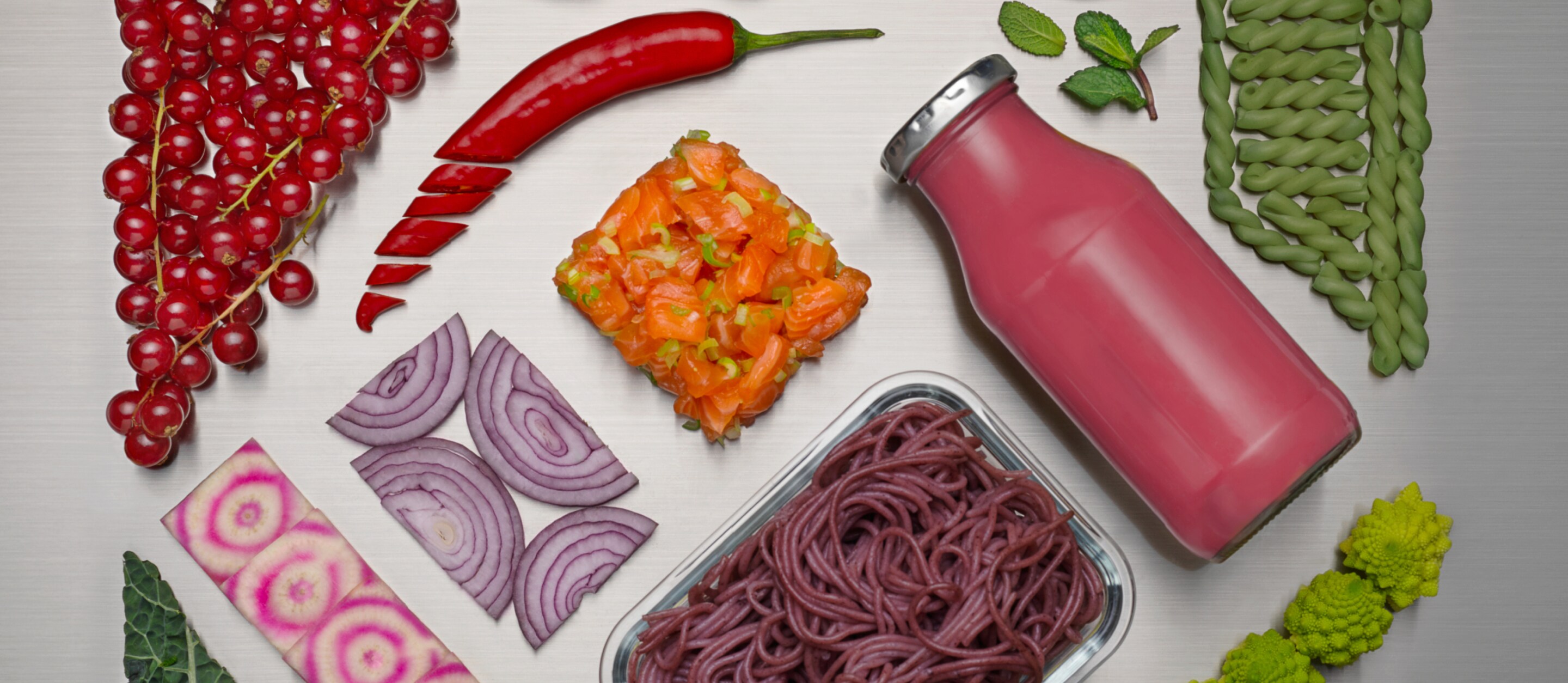 Different fresh food and drinks displayed on a silver background