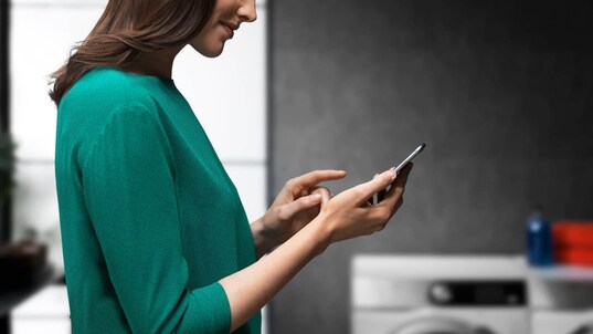Lady holding her phone using MyAEG Care App