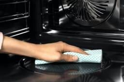 Hand cleaning an oven
